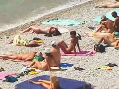 Muscular men and sleek women on a nude beach candid video