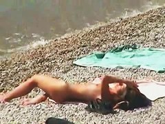Muscular men and sleek women on a nude beach candid video
