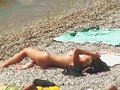 Muscular men and sleek women on a nude beach candid video