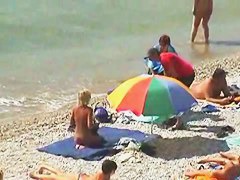 Muscular men and sleek women on a nude beach candid video