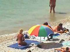 Muscular men and sleek women on a nude beach candid video