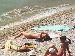Muscular men and sleek women on a nude beach candid video