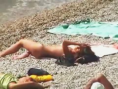 Muscular men and sleek women on a nude beach candid video