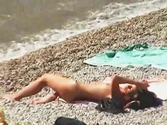 Muscular men and sleek women on a nude beach candid video