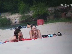 Beach voyeur video of shy topless girl sunbathing