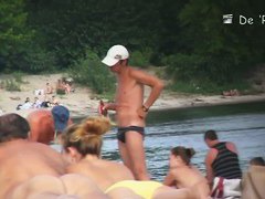 Beach voyeur video of shy topless girl sunbathing