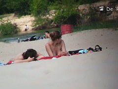 Beach voyeur video of shy topless girl sunbathing