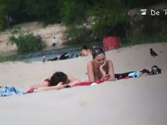 Beach voyeur video of shy topless girl sunbathing