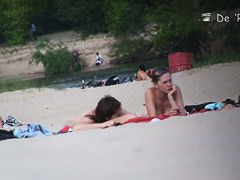 Beach voyeur video of shy topless girl sunbathing