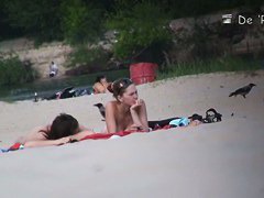 Beach voyeur video of shy topless girl sunbathing