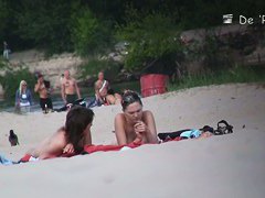 Beach voyeur video of shy topless girl sunbathing