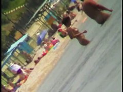 Voyeur view of fun in the water on a nudist beach