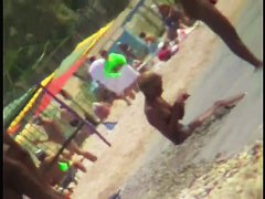 Voyeur view of fun in the water on a nudist beach