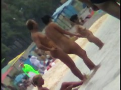 Voyeur view of fun in the water on a nudist beach