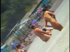 Voyeur view of fun in the water on a nudist beach