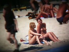 Buxom blonde filmed on a nudist beach
