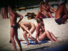 Buxom blonde filmed on a nudist beach