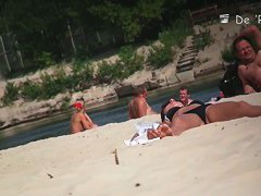 Naked babes spreading their pussies on the beach