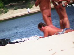 Naked babes spreading their pussies on the beach