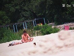 Voyeur beach nudist girl getting suntanned among bikini gals