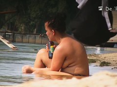 Fat amateur sits on beach voyeur cam with huge naked boobs
