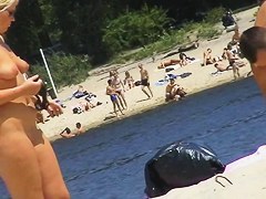 Blonde nudist girl creaming her naked body on the beach