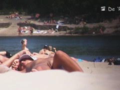 Nudist girl is lying showing the stretched slit to public