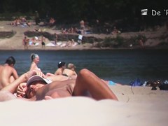 Nudist girl is lying showing the stretched slit to public