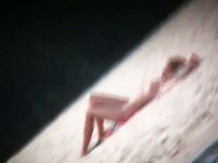 Spy cam shot of a hot nudist blond tanning on the beach