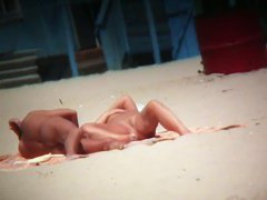 Couple exposing for the hidden cams at the beach