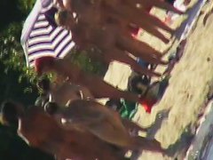 Mature babes with sexy bottoms move naked on the beach