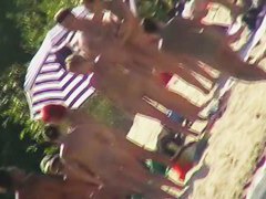 Mature babes with sexy bottoms move naked on the beach