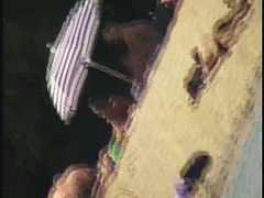 A dirty beach voyeur loves filming with his spy cam.