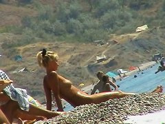 Sexy blond chicks sunbathing on a nude beach