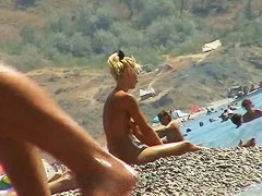 Sexy blond chicks sunbathing on a nude beach