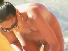 Beach voyeur video of a nude milf and a nude Asian hottie