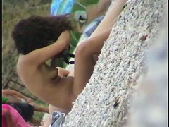 Lovely naked babe with perky tits at the beach