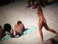 Voyeur on the beach capturing a tanned and naked girl