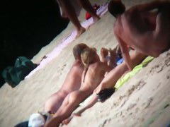 A couple sizzling hot blondes tanning in a nudist beach porno