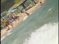 Nice babes are being filmed on camera on the beach