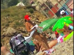 Nice babes are being filmed on camera on the beach