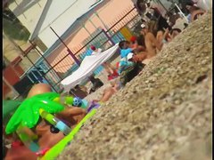 Nice babes are being filmed on camera on the beach