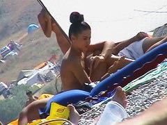 Hot red hair babe takes a nude sunbath at the beach