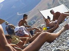 Hot red hair babe takes a nude sunbath at the beach