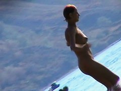 Hot red hair babe takes a nude sunbath at the beach