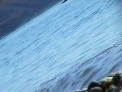 Hot red hair babe takes a nude sunbath at the beach