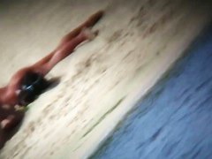 Nude beach blonde model being filmed by a voyeur