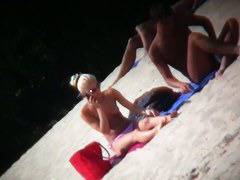 Nude beach blonde model being filmed by a voyeur