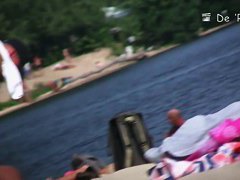 Stunning tanned brunette with a neat pussy in a beach porno video