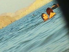 Ladies on the nudist beach exposed to the hidden cam